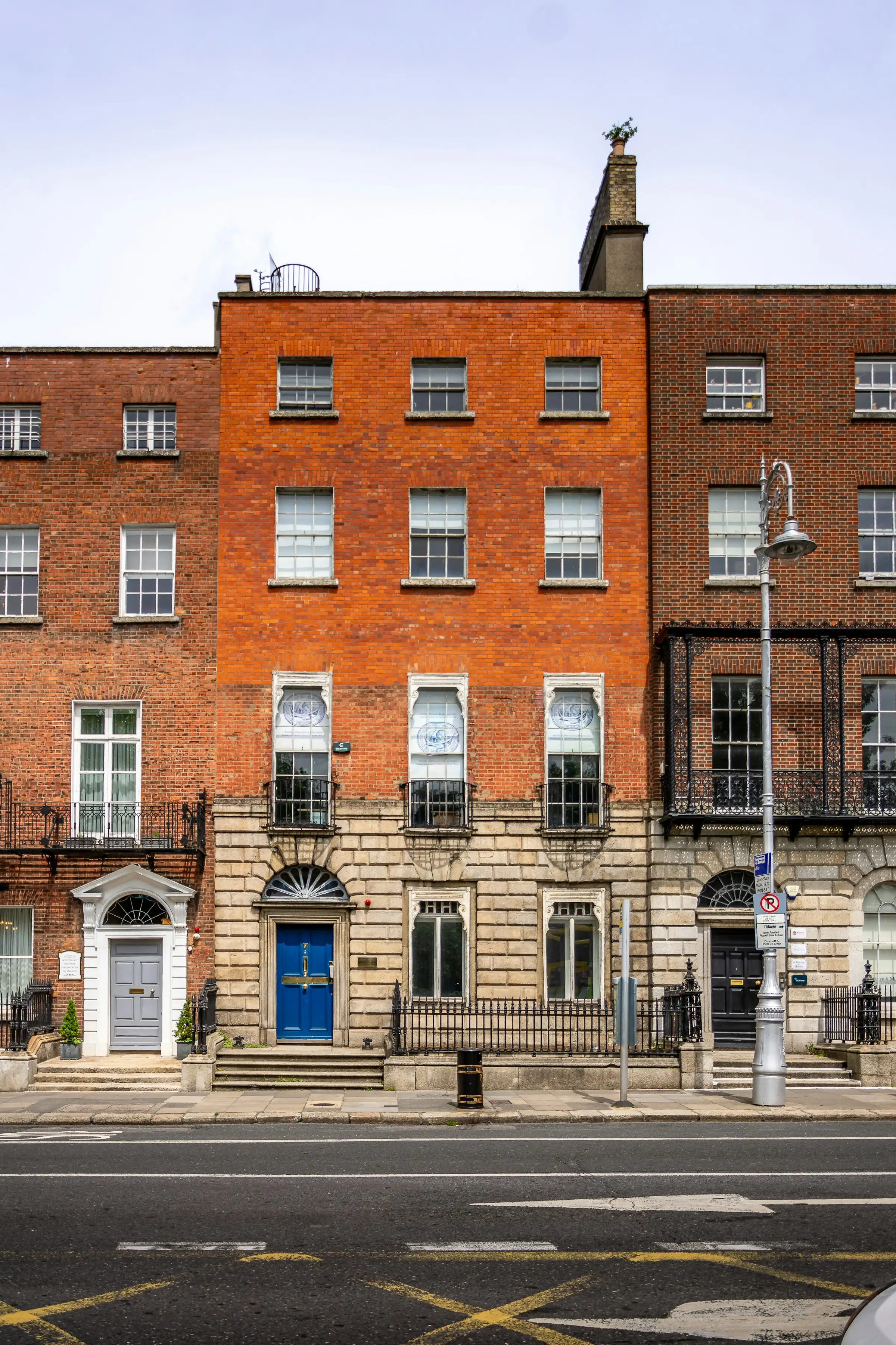 A row of period brick houses with a blue front door