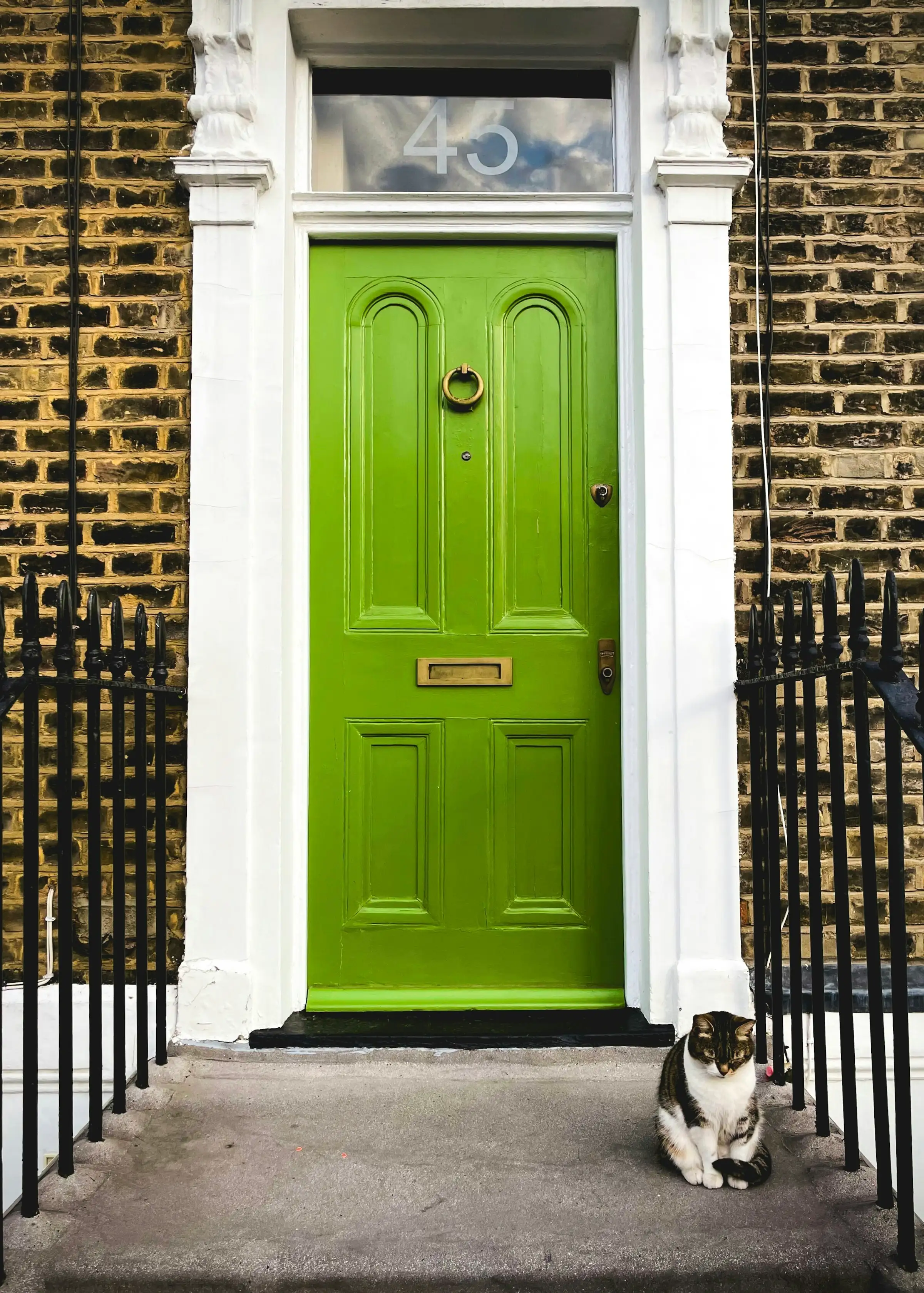 A green front door on an English terrace