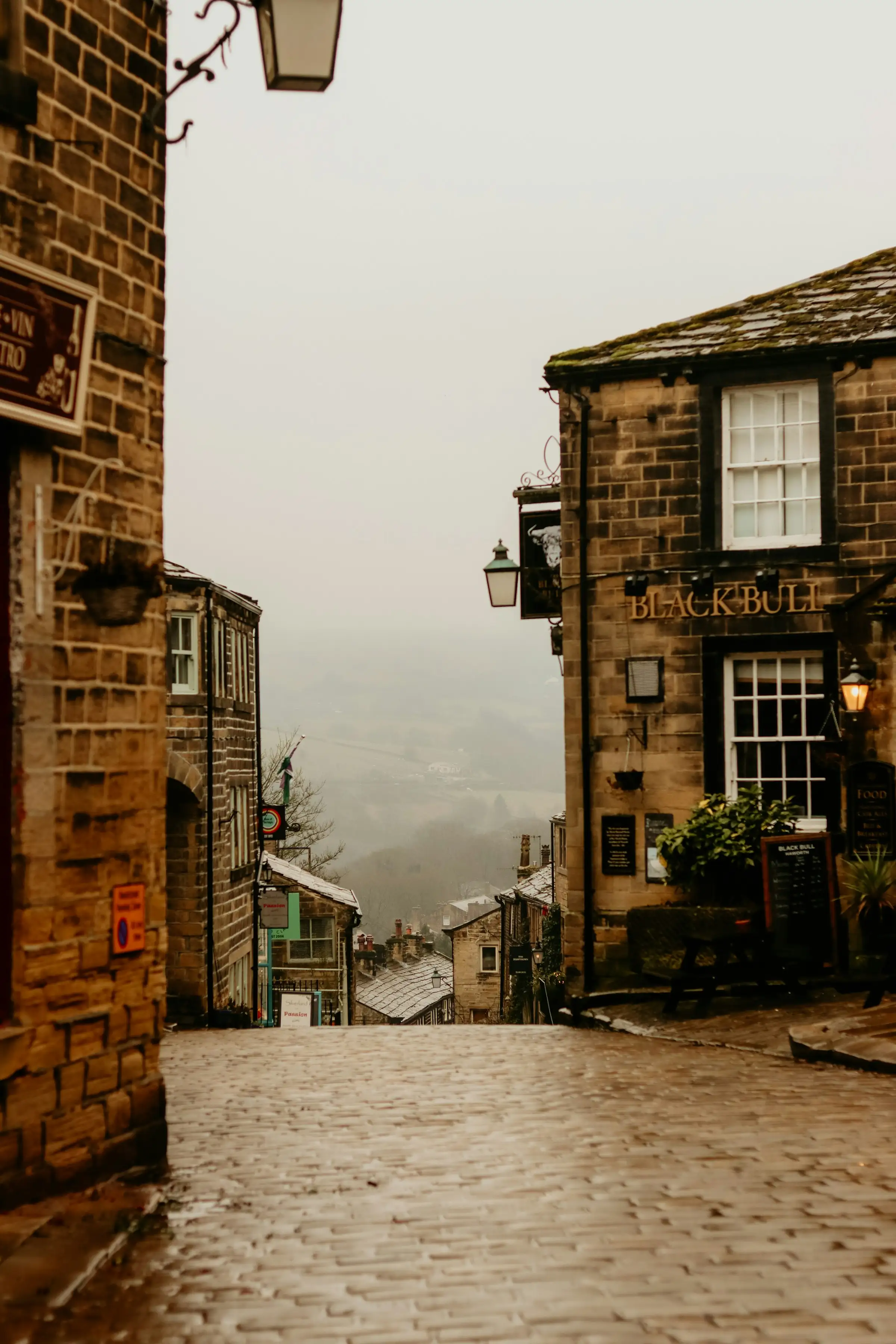 A misty English street of stone houses