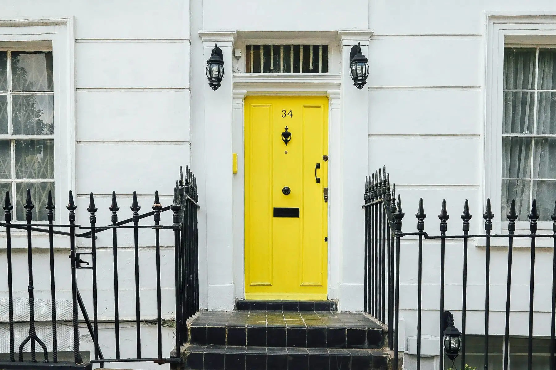A yellow front door on a London house